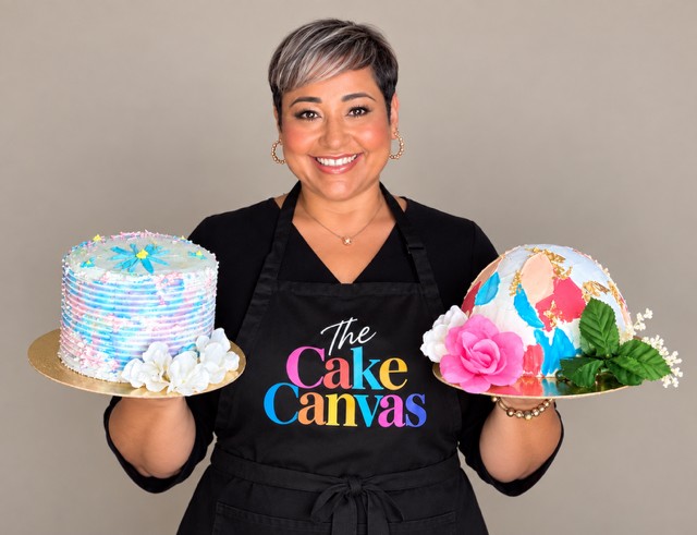 Katia of The Cake Canvas holding two colorful cakes
